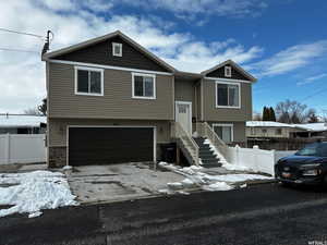 Bi-level home featuring a garage