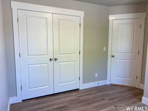 Unfurnished bedroom with a closet and light wood-type flooring