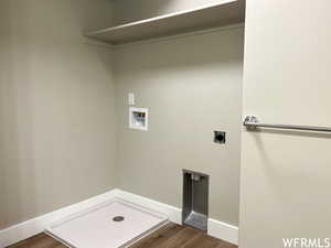 Laundry area featuring dark wood-type flooring, electric dryer hookup, and hookup for a washing machine