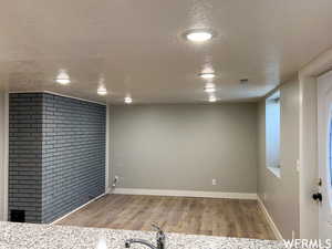 Interior space with wood-type flooring and a textured ceiling