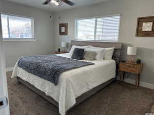 Bedroom with dark carpet and ceiling fan