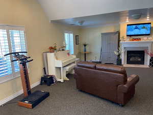 Living room with ornamental molding and carpet flooring