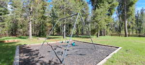 View of jungle gym with a lawn