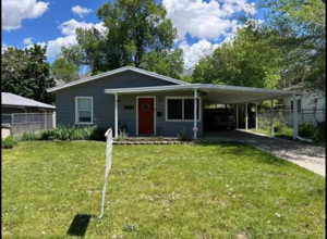 View of front of home featuring a carport and a front lawn