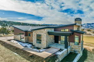 Rear view of house featuring a mountain view