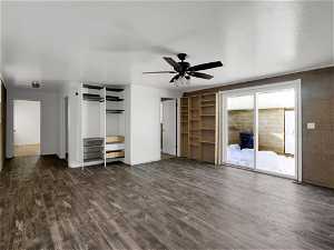 Unfurnished living room with dark hardwood / wood-style flooring and ceiling fan