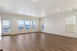 Unfurnished room with dark hardwood / wood-style flooring and a wealth of natural light