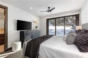 Bedroom featuring access to outside, ensuite bath, and ceiling fan