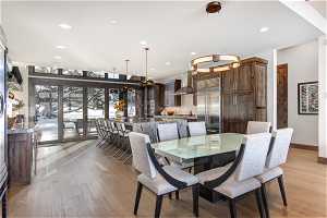 Dining space with light hardwood / wood-style flooring