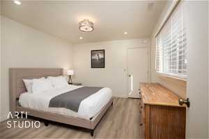 Bedroom with light wood-style floors