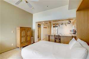 Bedroom featuring white fridge and ceiling fan