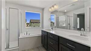Bathroom featuring hardwood / wood-style floors, independent shower and bath, and double sink vanity