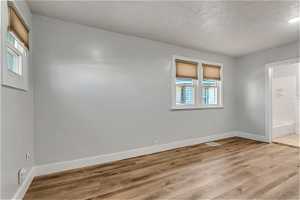 Spare room featuring luxury vinyl planking floors, two-toned paint, and lots of natural light.