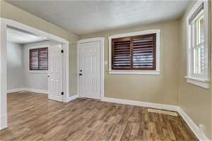 Family room featuring high-end luxury vinyl planking floor, two-toned paint and decorative wood blinds.