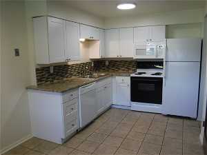 Main level apartment kitchen with new cabinets and granite counter tops, tile back splash.