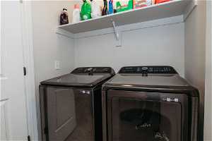 Laundry room with washer and clothes dryer