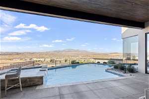 View of swimming pool featuring pool water feature, a patio, and a mountain view