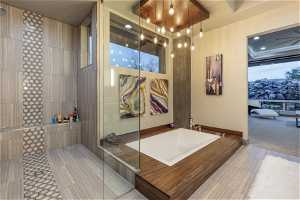 Bathroom with a tile shower and a raised ceiling