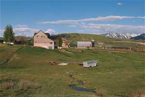 View of front of property featuring a mountain view and a rural view
