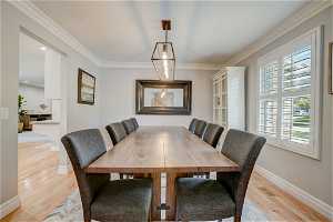 Dining area featuring light hardwood / wood-style floors and ornamental molding