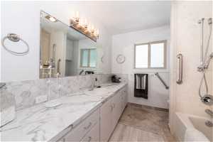 Full bathroom with oversized vanity, a healthy amount of sunlight, tile flooring, and toilet