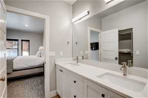 Bathroom featuring vanity with extensive cabinet space and dual sinks