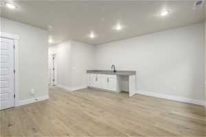 Interior space with sink and light hardwood / wood-style floors