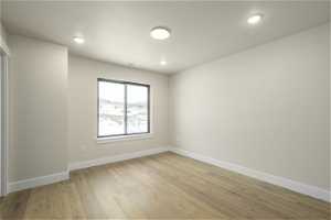 Unfurnished room with light hardwood / wood-style flooring