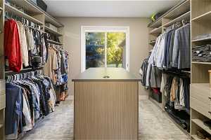 Spacious primary closet with ample shelving