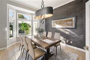 Dining area featuring light hardwood / wood-style flooring and ornamental molding