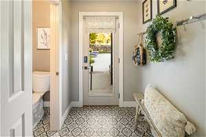 Doorway to outside featuring light tile floors