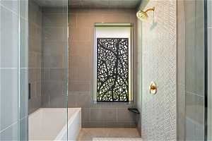 Bathroom featuring tile walls and tile floors