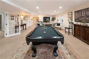 Game room with light carpet and billiards