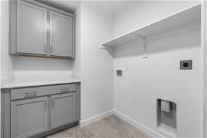 Laundry room featuring cabinets, washer hookup, and electric dryer hookup