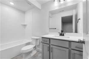 Full bathroom featuring tile flooring, shower / washtub combination, toilet, and large vanity