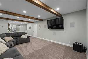 Living room featuring beam ceiling and carpet flooring