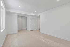 Unfurnished bedroom with light carpet