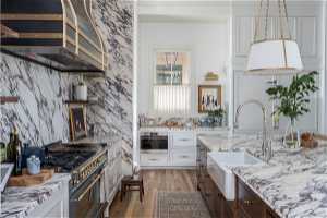 Kitchen featuring oven, range with two ovens, sink, white cabinetry, and dark hardwood / wood-style floors