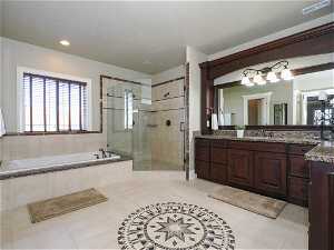 Primary Suite Bathroom with separate tub and shower, double sinks, and great light
