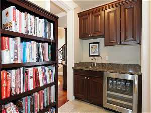 Butler's pantry with sink, granite counter and beverage cooler