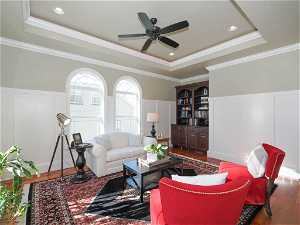 Formal Living room featuring ornamental molding, a tray ceiling, and indirect lighting.