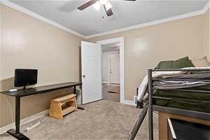 Bedroom featuring crown molding, light carpet, and ceiling fan