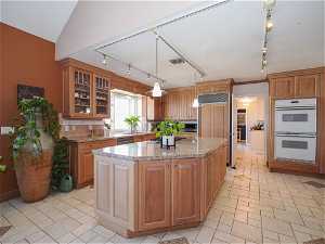 Custom Limed Cherry cabinets with granite counters and built in Refrigerator.
