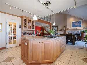 Granite Island Kitchen with Limed Cherry cabinets, large pantry and Gas cooktop