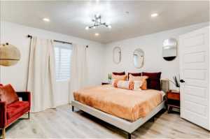 Bedroom featuring a chandelier and light hardwood / wood-style floors