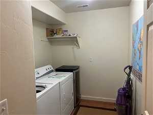 Clothes washing area with separate washer and dryer.  Wine fridge included.