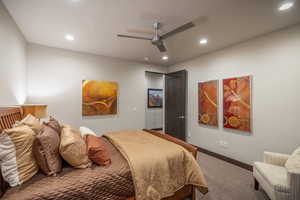 Carpeted bedroom with ceiling fan