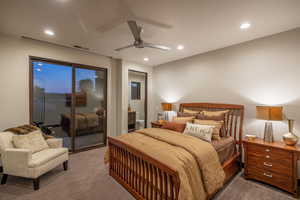 Carpeted bedroom featuring access to outside and ceiling fan