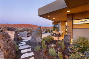 Yard at dusk featuring a patio area and a mountain view