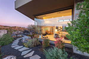 Yard at dusk featuring a patio area and an outdoor hangout area